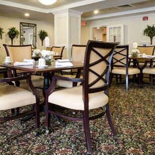 A well-decorated dining room with elegant chairs and tables.