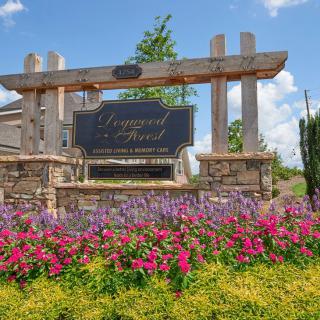 Entrance sign with vibrant flower landscaping.