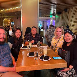 A group of friends enjoying a dinner together at a lively restaurant.
