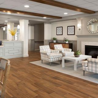 A cozy lobby area featuring comfortable seating, a fireplace, and elegant decor.
