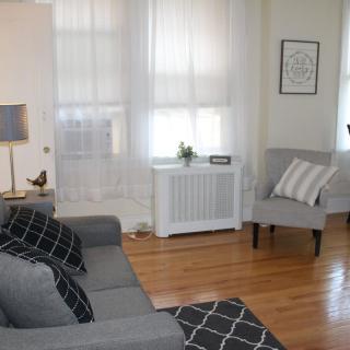 A cozy living room with gray furniture and soft lighting.
