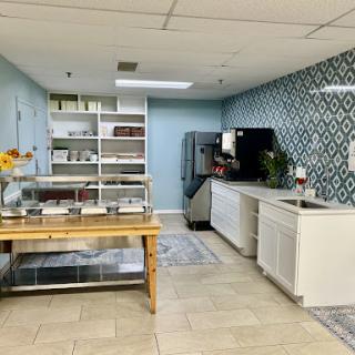 A modern kitchen space featuring decorative walls, ample storage, and a beautifully organized countertop.
