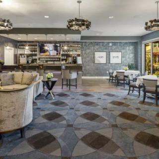 A modern lounge area featuring comfortable seating and a stylish bar.