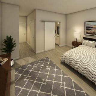 A minimalist bedroom featuring modern decor with a cozy bed, geometric-patterned rug, and stylish furnishings.