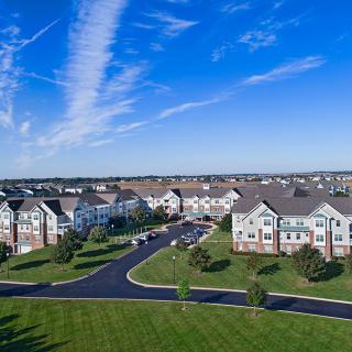 Aerial view of a residential apartment complex surrounded by greenery.