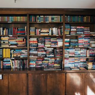 A densely packed bookshelf filled with a variety of books.