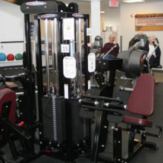 A multi-station gym machine designed for indoor workout and strength training.