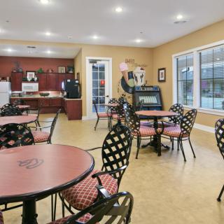 A cozy cafe interior with seating and a kitchen area.