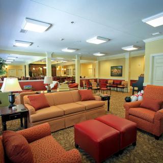 A cozy lounge area with comfortable seating and warm lighting.
