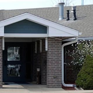 A brick building entrance with a covered walkway.