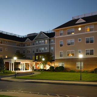 Illuminated hotel building exterior at night.