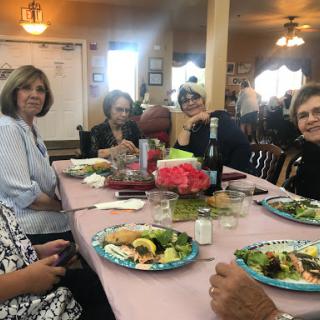 A cheerful lunch gathering among friends enjoying their meal.