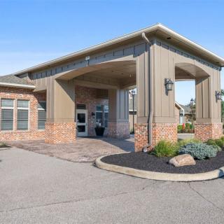 A modern commercial building with a welcoming entrance and landscaped surroundings.