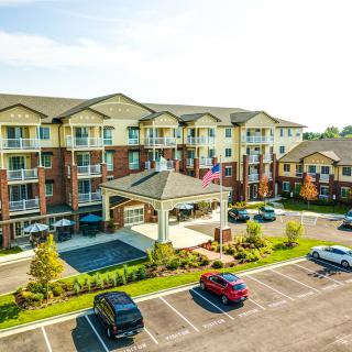 A large apartment complex with a spacious parking lot and landscaped surroundings.