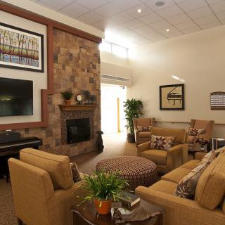 A cozy living room with a fireplace, comfortable seating, and elegant decor.
