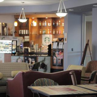 A cozy cafe interior with comfortable seating and a well-lit counter area.
