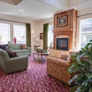 A cozy living room with a fireplace and comfortable seating arrangement.