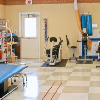 A rehabilitation center featuring various exercise equipment and therapy areas.