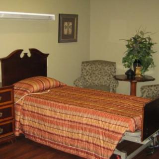 A cozy bedroom with a single bed, nightstand, and decorative items.