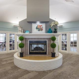 A modern living room with a central fireplace and elegant decor.
