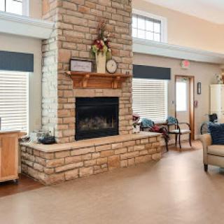 A cozy living room featuring a stone fireplace and ample seating.