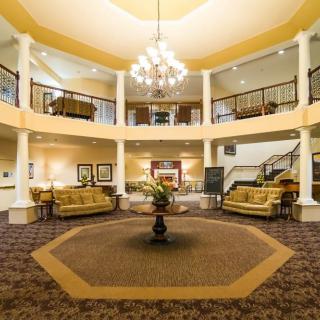 A luxurious lobby with a grand chandelier, elegant seating areas, and decorative elements.