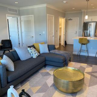 A cozy and modern living room featuring a stylish sofa and a gold coffee table.