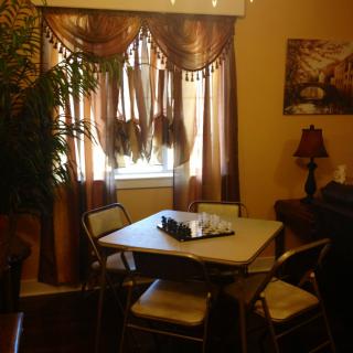 Cozy dining area with a table, chairs, and warm lighting.