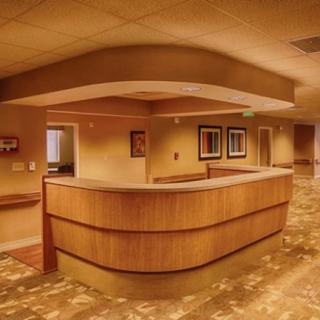 A modern reception area with a wooden desk and warm lighting.