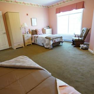 A cozy bedroom with twin beds and pastel-colored decor.