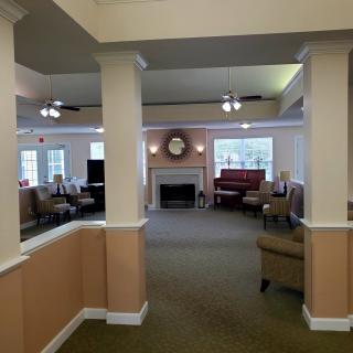 A spacious living room with a fireplace and seating area.