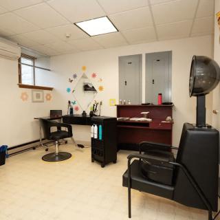 A cozy hair salon with styling chairs and mirrors, ready for customers.