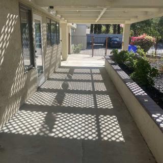 Sunlit corridor with patterned shadows.