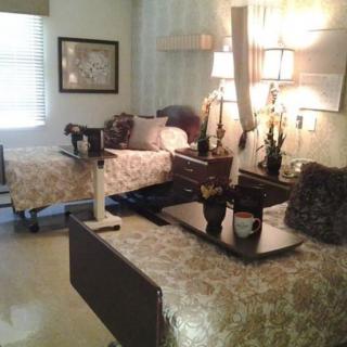 A well-furnished hospital room with two beds and decorative elements.