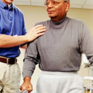 A person receiving assistance during a physical therapy session.