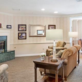 A cozy living room featuring comfortable sofas, a fireplace, and elegant decor.
