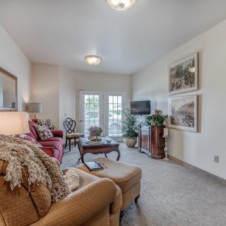 A cozy living room with comfortable seating, a coffee table, and stylish decor.