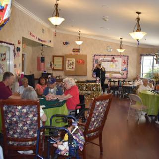 A lively dining area in a community center where seniors are enjoying their time together.