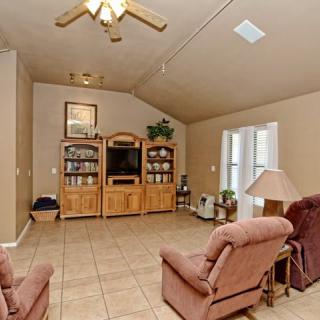 A cozy living room with an entertainment center and comfortable seating.