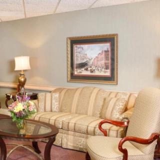 A cozy living room with a striped sofa, a coffee table, and elegant decor.