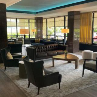A modern hotel lobby with stylish furniture and ambient lighting.