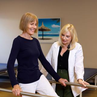 A patient receives guidance from a healthcare professional during a physical therapy session.