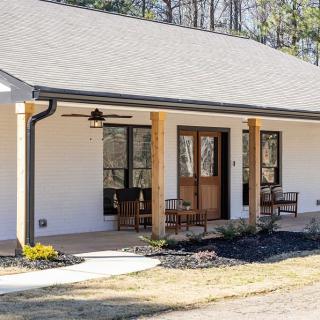 A cozy bungalow with a welcoming porch and outdoor seating area.