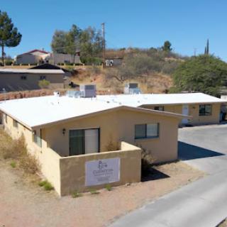 Aerial view of a suburban residential building with white roofing.