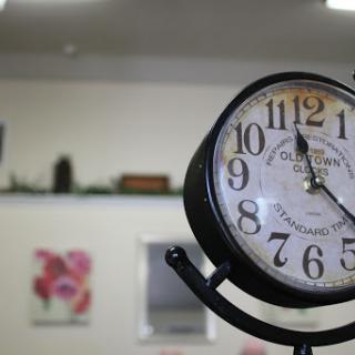 A classic wall clock displaying the time in a cozy interior setting.