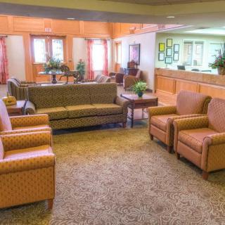A cozy lobby with comfortable seating arrangements and a reception desk.