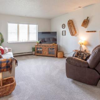 A cozy living room with comfortable seating, a television, and decorative elements.