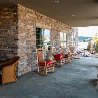 A cozy porch with rocking chairs and a scenic view.
