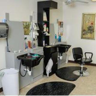 A modern hair salon interior with styling stations and chairs.
