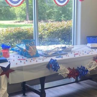 A table decorated with patriotic red, white, and blue items for a party.